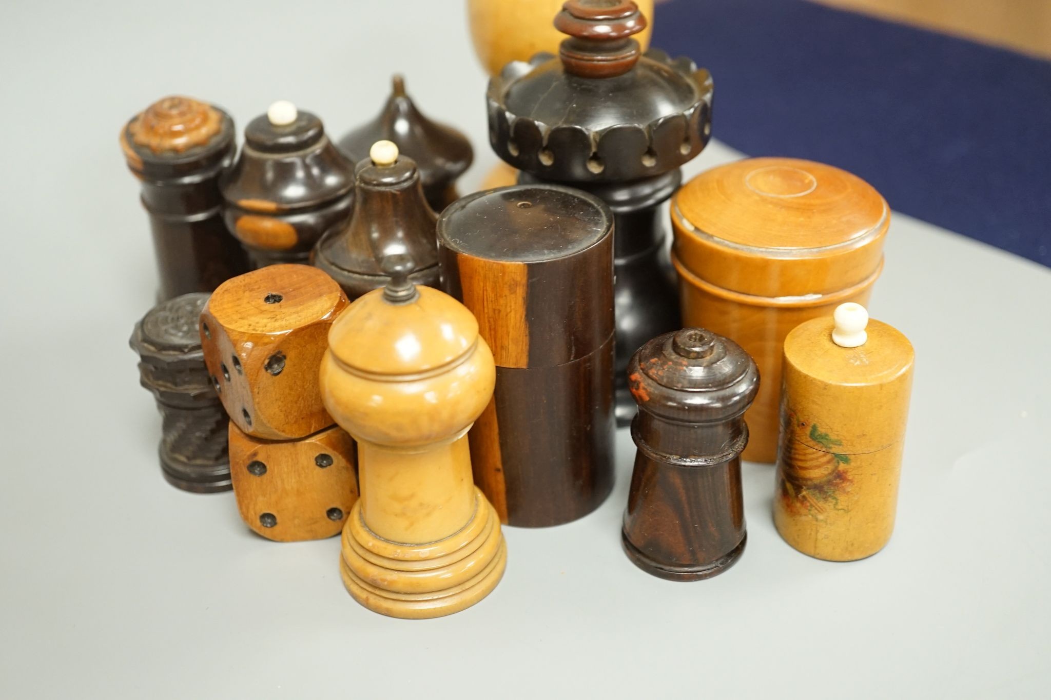 Nine Victorian turned or carved treen match holders with ‘go to bed’ finials, a treen double measure, cased glass measure and engine turned container (13)